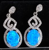 A pair of silver metal CZ and Opalite earrings.