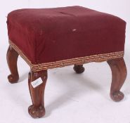 A good Victorian walnut stool raised on shaped legs with carved scroll feet having a webbed and