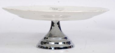 A vintage 1950's Midwinter Tazza raised on chromium base with painted cocker spaniel design.