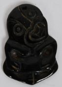 A Maori carved green stone ( jade ) Tiki pendant Of typical form, with suspension hole.