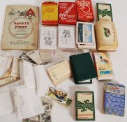 A small collection of vintage and retro playing cards along with some vintage cigarette cards,