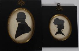 A pair of vintage style framed and glazed portrait silhouettes.