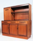 A 1970's G-Plan teak wood Fresco sideboard having a series of cupboards and drawers flanking an