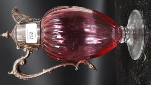 A 19th century Regency style silver plated cranberry claret jug with shaped handle and decorative