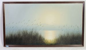 A large framed oil on canvas of Geese in flight over a lake signed to the lower corner K Sander