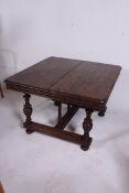 A 19th century Victorian Triple leaf French walnut extending dining table raised on turned legs