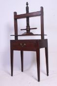 A 19th Georgian oak book press on table.