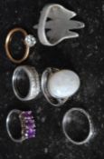 A collection of six silver metal rings, five stamped 925 along with one unmarked,