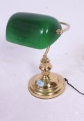 A 20th century contemporary brass base bankers / desk lamp having green shade on shaped column