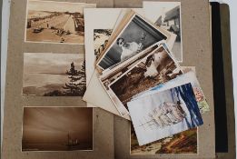 A vintage postcard album containing several postcards,