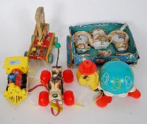 A collection of various vintage Fisher Price pull along items together with a boxed childs teaset