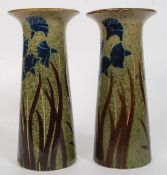 A pair of fat lava / studio pottery style vases having flared rims, Iris decoration.