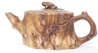 A 19th century Chinese oriental Yixing teapot in the form of a tree stump.