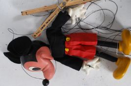 A Pelham Puppet Mickey Mouse with yellow shoes complete with string being inscribed to wood