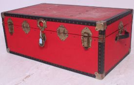 A 20th century retro red and metal strapped steamer trunk case having hinged centre.