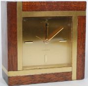 A retro vintage mid 20th century gilt brass and mahogany vintage alarm clock by Looping having