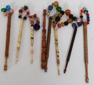 A collection of 19th century lace bobbins, one ivory and some decorated with beads.
