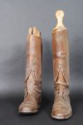 A pair of early 20th century leather boots together with shoe / boot stretchers