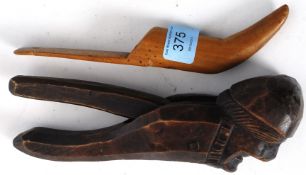 A pair of treen nutcrackers in the form of an old man in bedcap together with a treen knitting