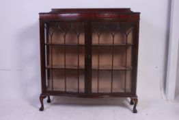 A 1930's mahogany serpentine fronted Queen Anne china display cabinet.
