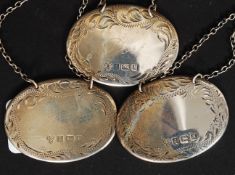 A collection of three hallmarked silver decanter / bottle lables, each hallmarked,
