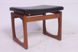 A retro G - Plan teak wood and black Leatherette topped stool bearing the G - plan sticker to the