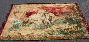 A wall hanging tapestry rug depicting Elephants and other animals in a naturalistic setting
