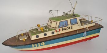 A retro 20th century remote control model of a boat - pilot launch having some mechanics to