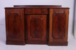A Victorian inverted breakfront mahogany sideboard.