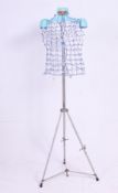 A Twin fit adjustable dress makers dummy on an adjustable tripod stand. H170 cm tall.