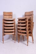 A stack of 12 retro 1950's ply panel wood Industrial school chairs raised on bentwood legs with