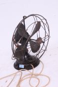A vintage 1930's Art Deco GEC black metal industrial office fan having copper blades with cage,