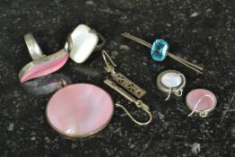 A contemporary rose quartz stone silver necklace pendant together with matching earrings and ring.