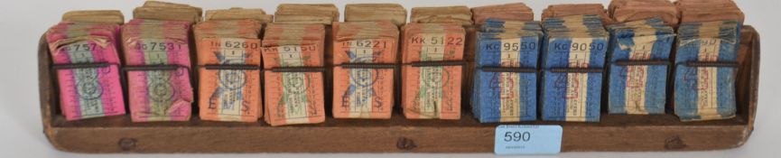 A vintage mid 20th century London Transport Co bus clippies stub ticket holder with tickets.