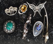 A collection of 7 silver brooches to include  butterfly, citrine stone,bar brooch, malachite etc.