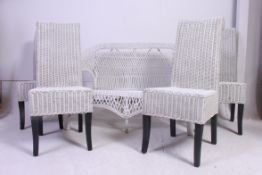 A vintage 20th century whicker painted conservatory sofa together with 4 matching dining chairs.