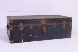 A large vintage blue shipping trunk, with metal clasps and hinges,