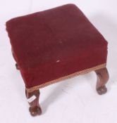 A good Victorian walnut stool raised on shaped legs with carved scroll feet having a webbed and