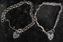 2 silver locket bracelets both with heart padlocks, one of curb link form, the other gate linked.