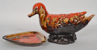 A retro fat lava style studio ceramic duck along with a similar near matching plate
