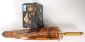 A vintage mid 20th century hand painted Japanese hand painted parasol along with a painted