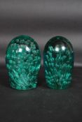 A near pair of  Victorian large green control bubble paper dumps, possibly Nailsea glass.