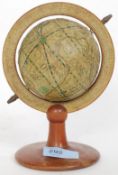 A vintage style 20th century small desktop globe, with printed paper applied to the globe,
