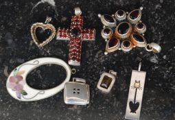 A collection of seven silver pendants to include paste stone crucifix, heart, citrine stone,