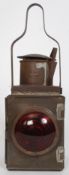 An early 20th century rail guards oil lamp of square form having red lense complete with oil tray
