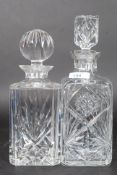Two vintage cut glass decanters both with stoppers.