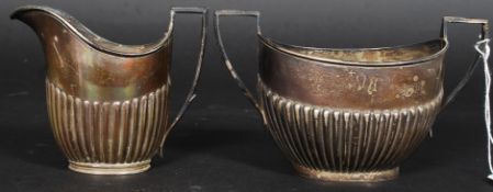 A matched set of hallmarked silver Queen Anne style ribbed sugar bowl and similar milk jug.