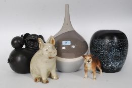 Two 20th century studio glass vases, along with two comical pottery figurines of pigs.