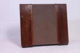 A vintage floor standing wooden cased Wharfedale speaker having a metal mesh finish.