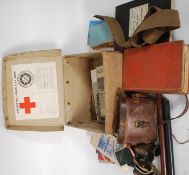 A collection of military items to include Military Books, Binoculars stamped AM,